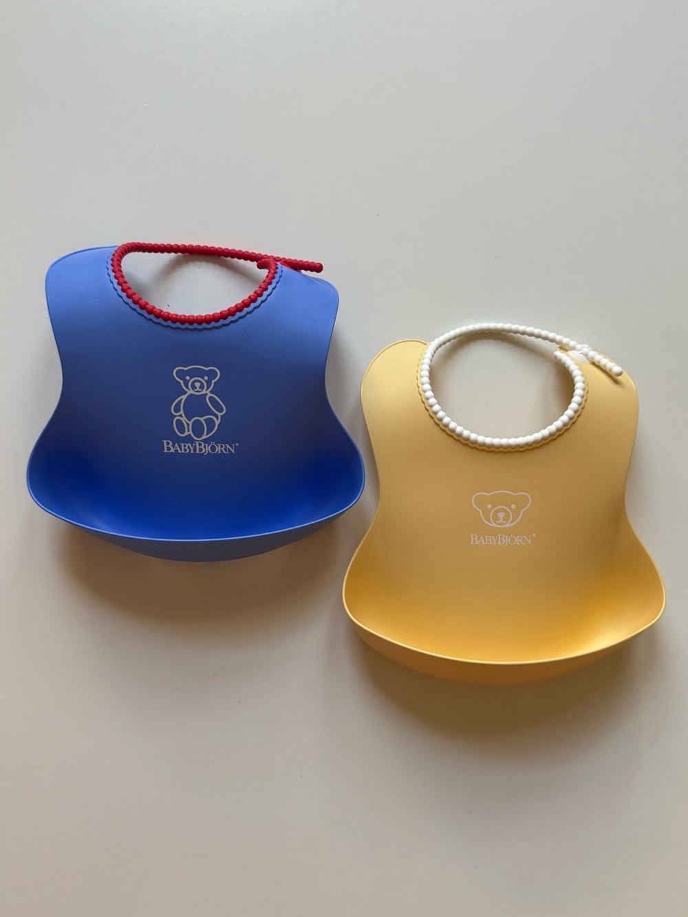 Set of 2 BabyBjorn Feeding Bibs - Blue & Yellow